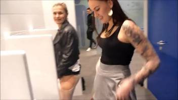 Pair of females defecating and urinating in the gentlemen's bathroom